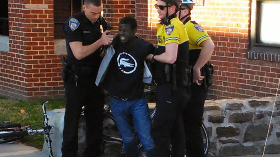 Freddie Gray is seen being taken into custody by Baltimore Police on April 12 in this still from a cell phone video. (Baltimore Sun)