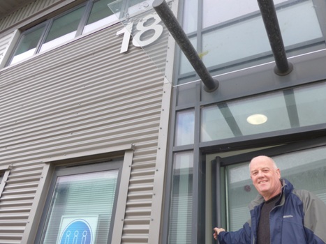 John Corrall outside the new building